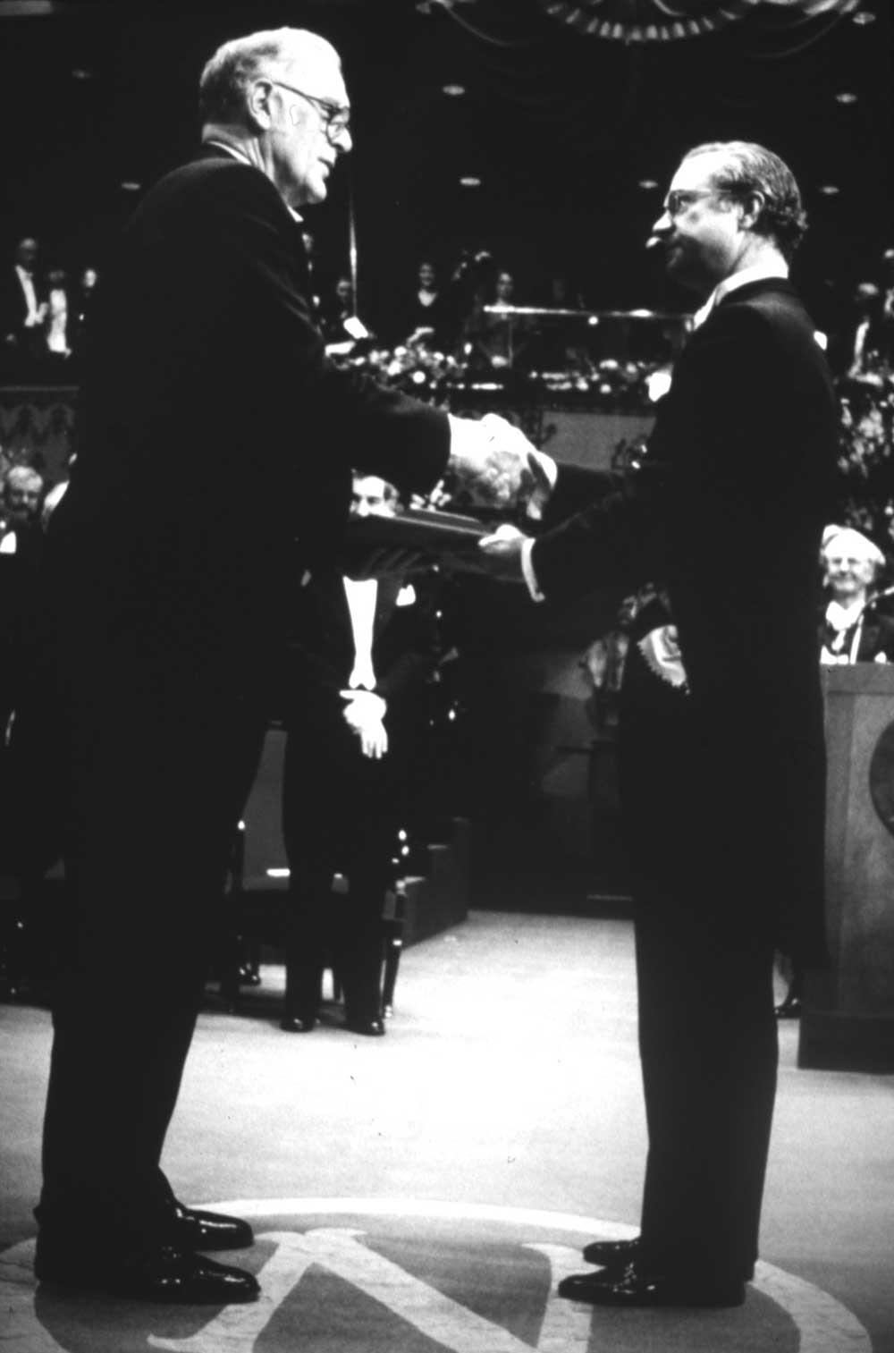 Frederick Reines and F. Sherwood Rowland receive Nobel prizes