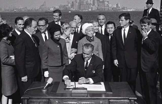President Lyndon Johnson and other dignitaries at 1965 Act signing ceremony